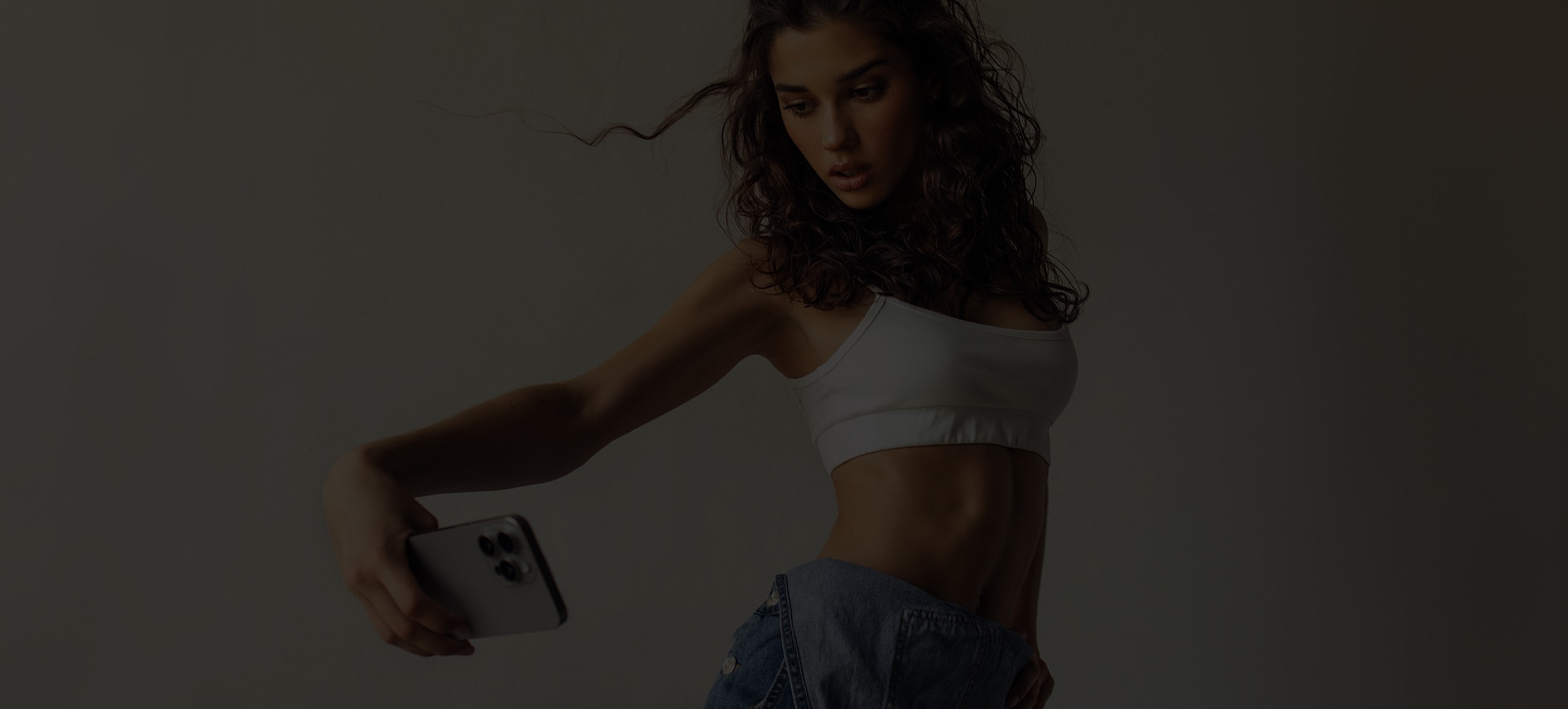 Woman taking a selfie in casual attire.