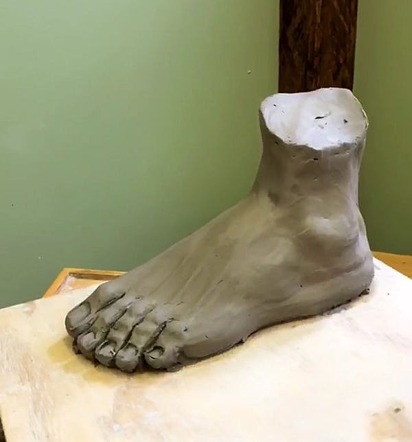 Clay sculpture of a human foot.