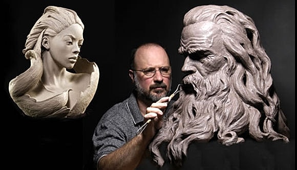 Sculptor working on detailed clay sculptures.