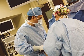 Surgeons performing a procedure in operating room.