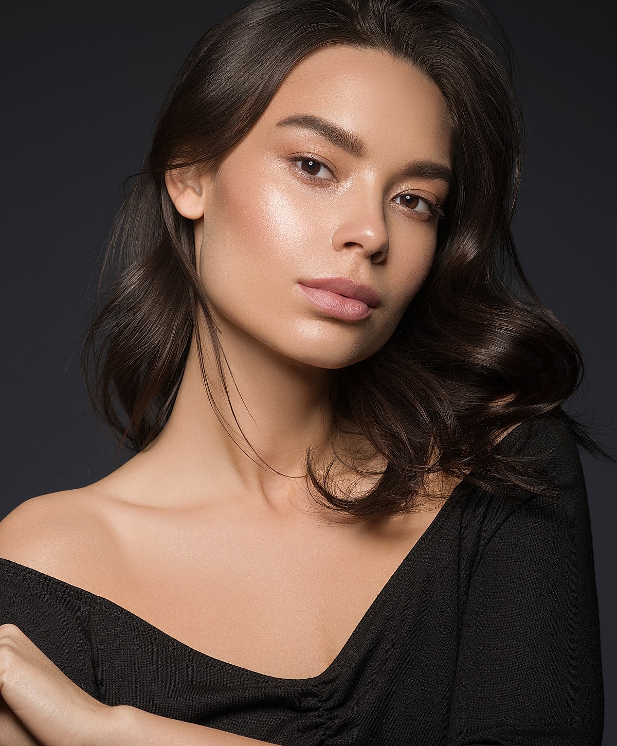 Woman in black athletic wear posing elegantly.