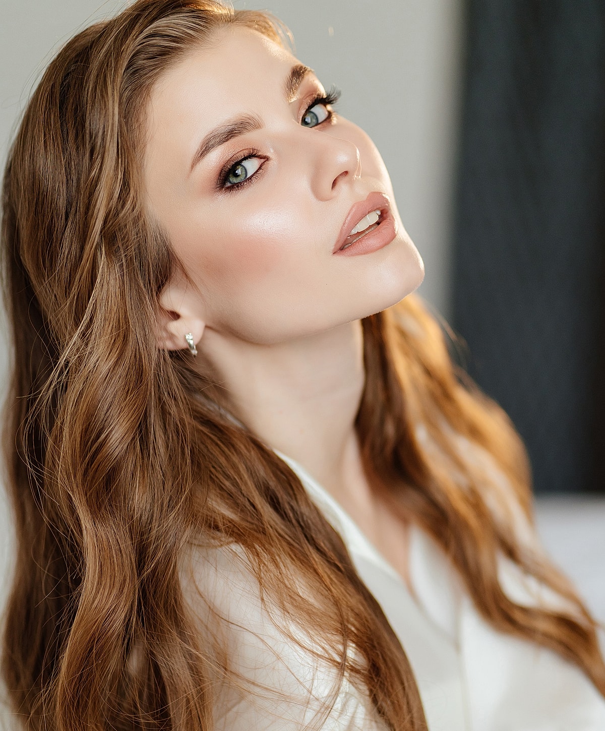 Portrait of a woman with flowing, wavy hair.