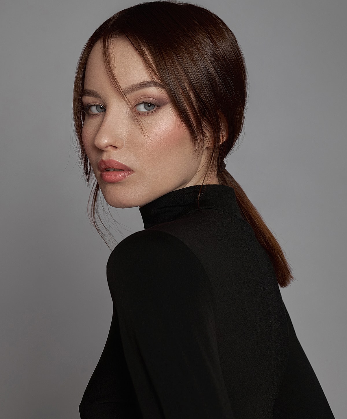 Portrait of woman in black turtleneck, turned profile.