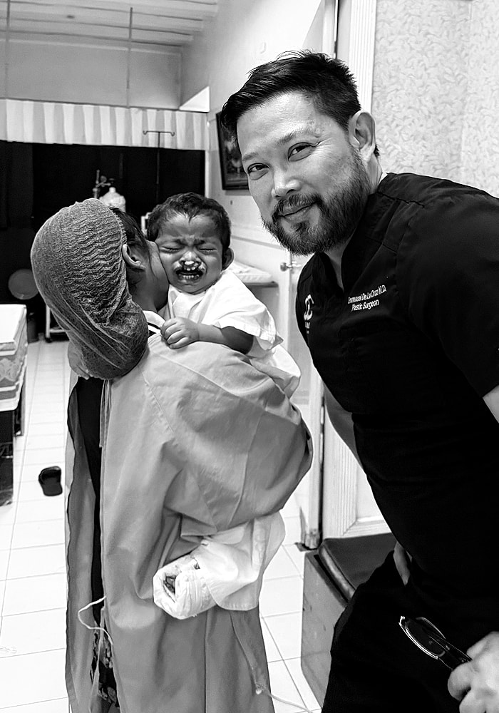 Child crying with caregivers and doctor in clinic.