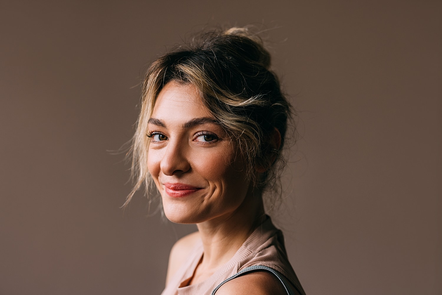 Woman in black athletic wear posing elegantly.
