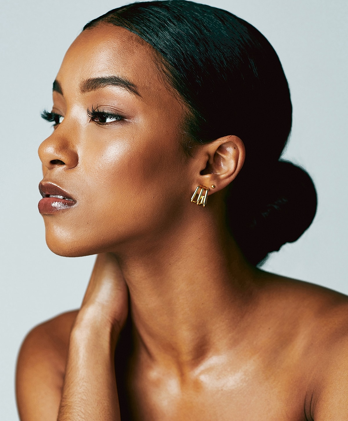 Woman in black athletic wear posing elegantly.