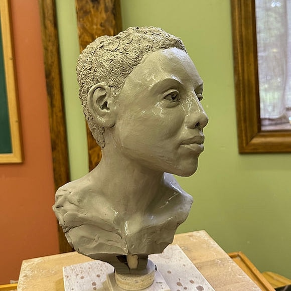 Sculpture of a human head in progress.