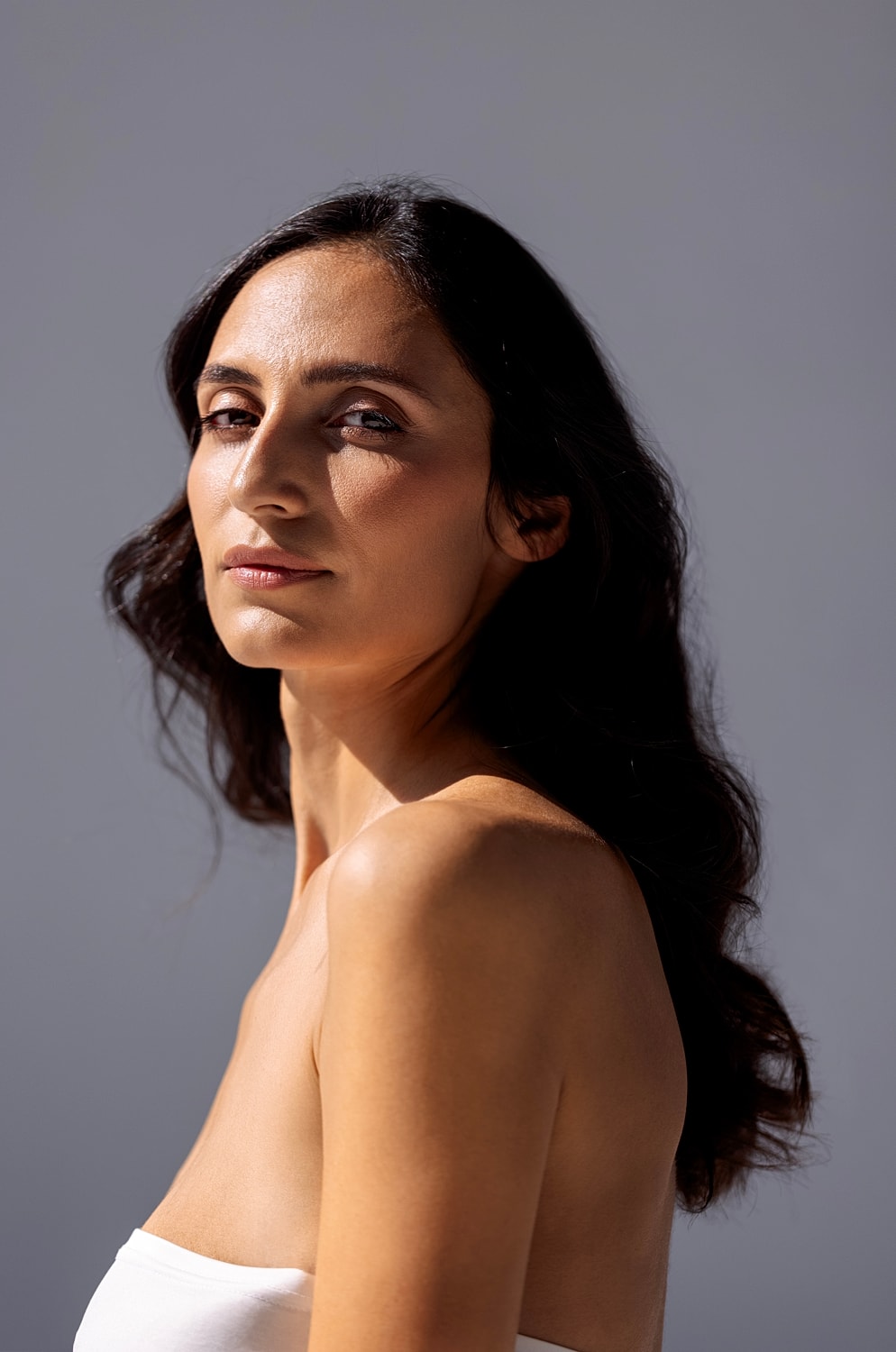 Woman in black athletic wear posing elegantly.