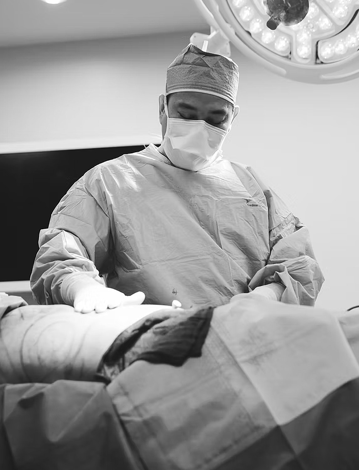 Surgeon performing a procedure in operating room.