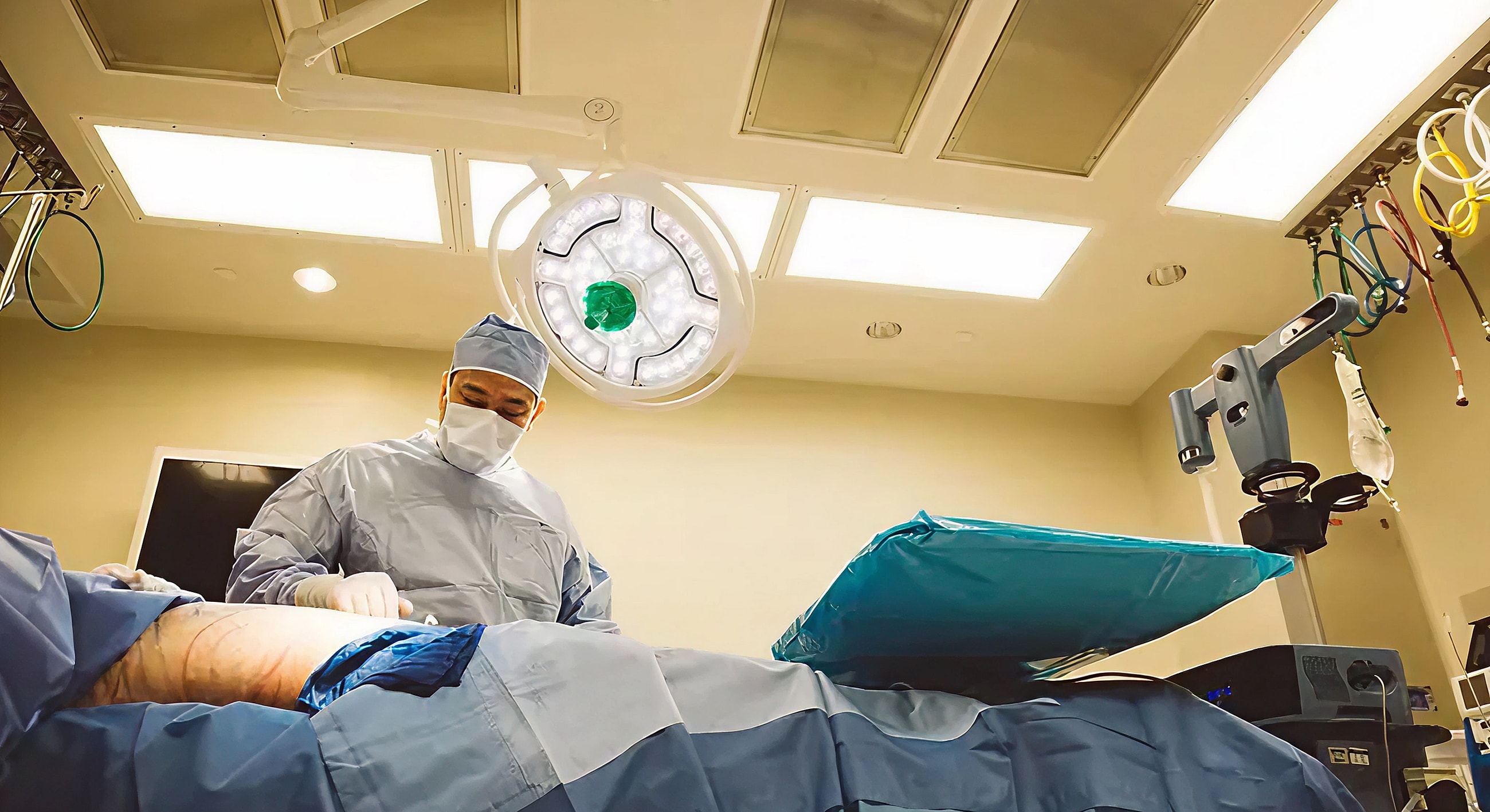 Surgeon performing procedure in operating room.