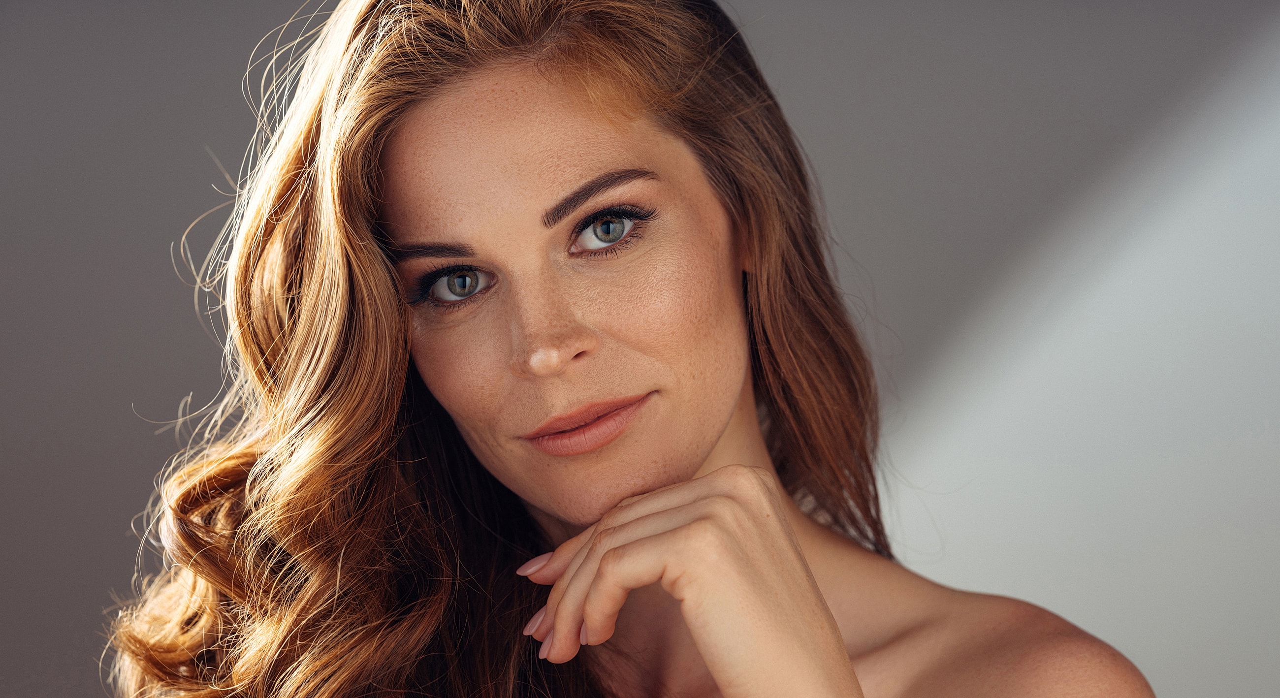 Close-up portrait of a woman with wavy hair.
