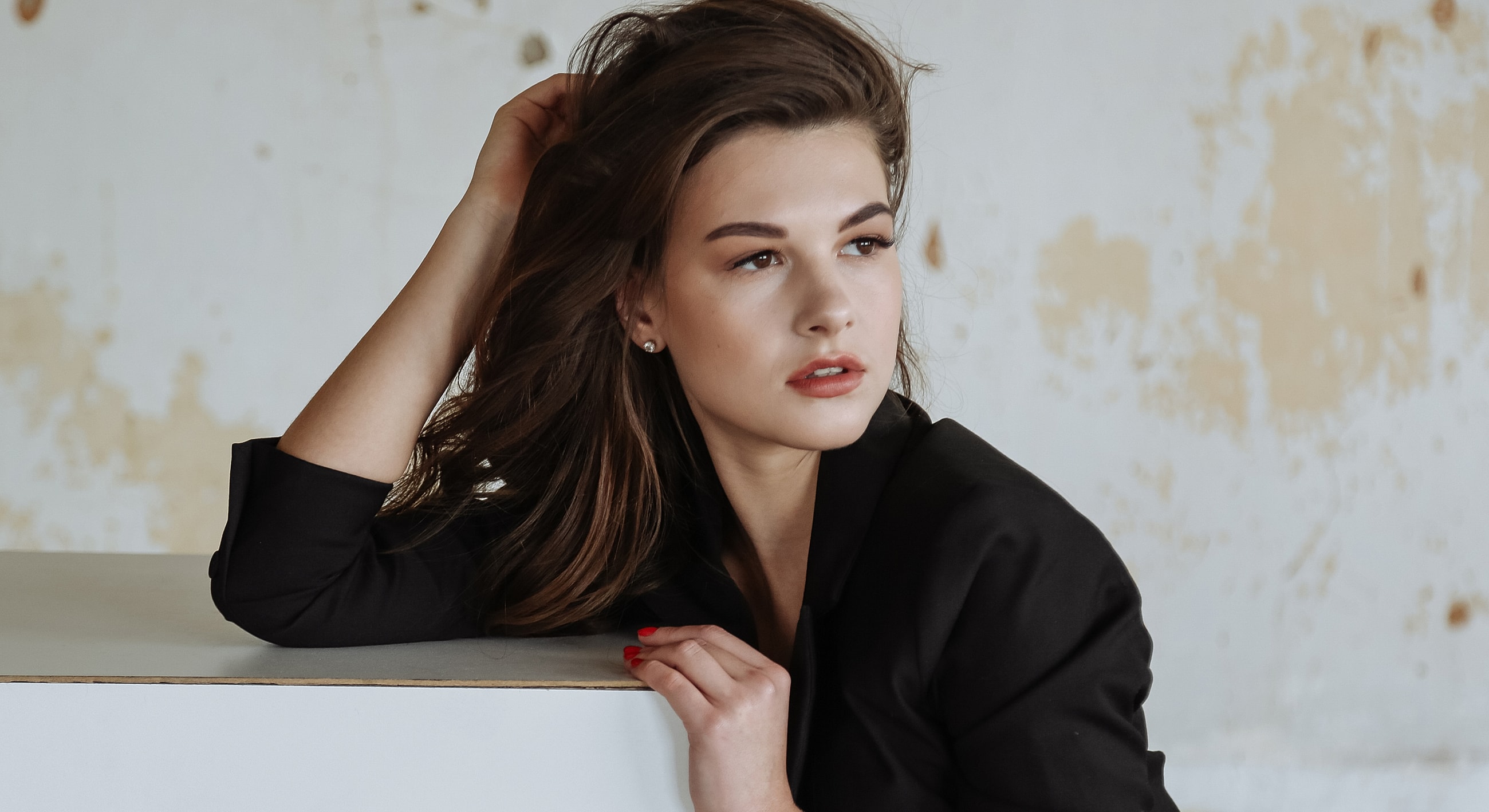 Young woman with long hair in stylish pose.