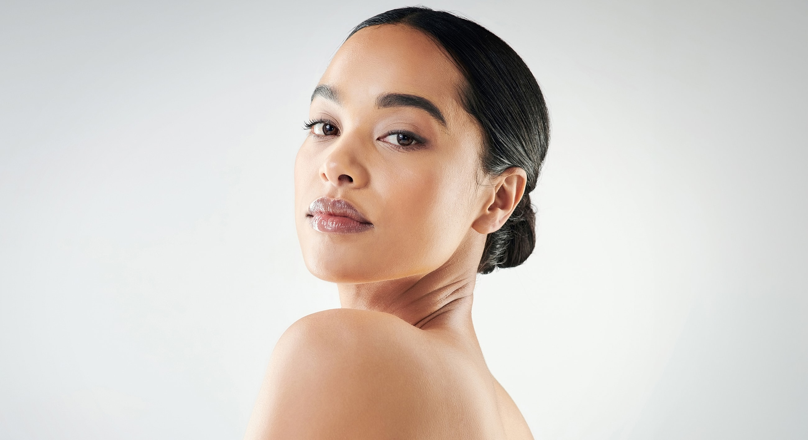 Woman with sleek hair, graceful expression.