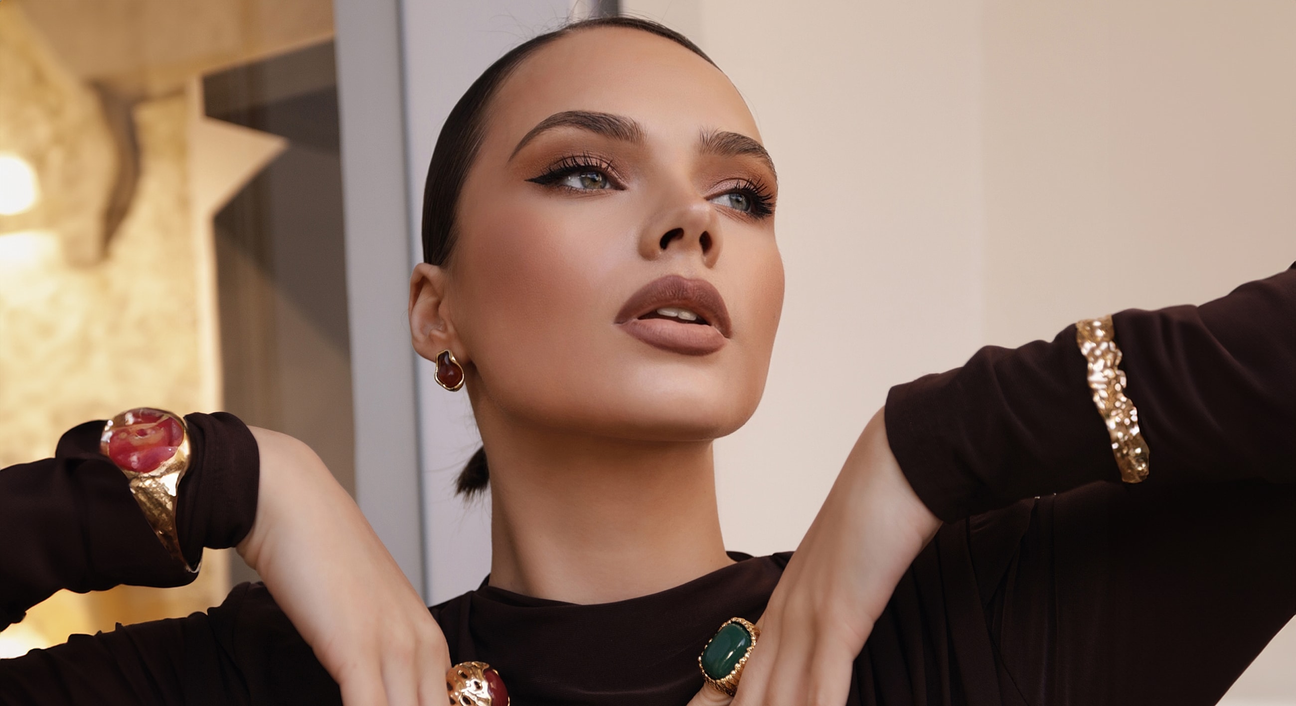 Model showcasing elegant jewelry and fashion.