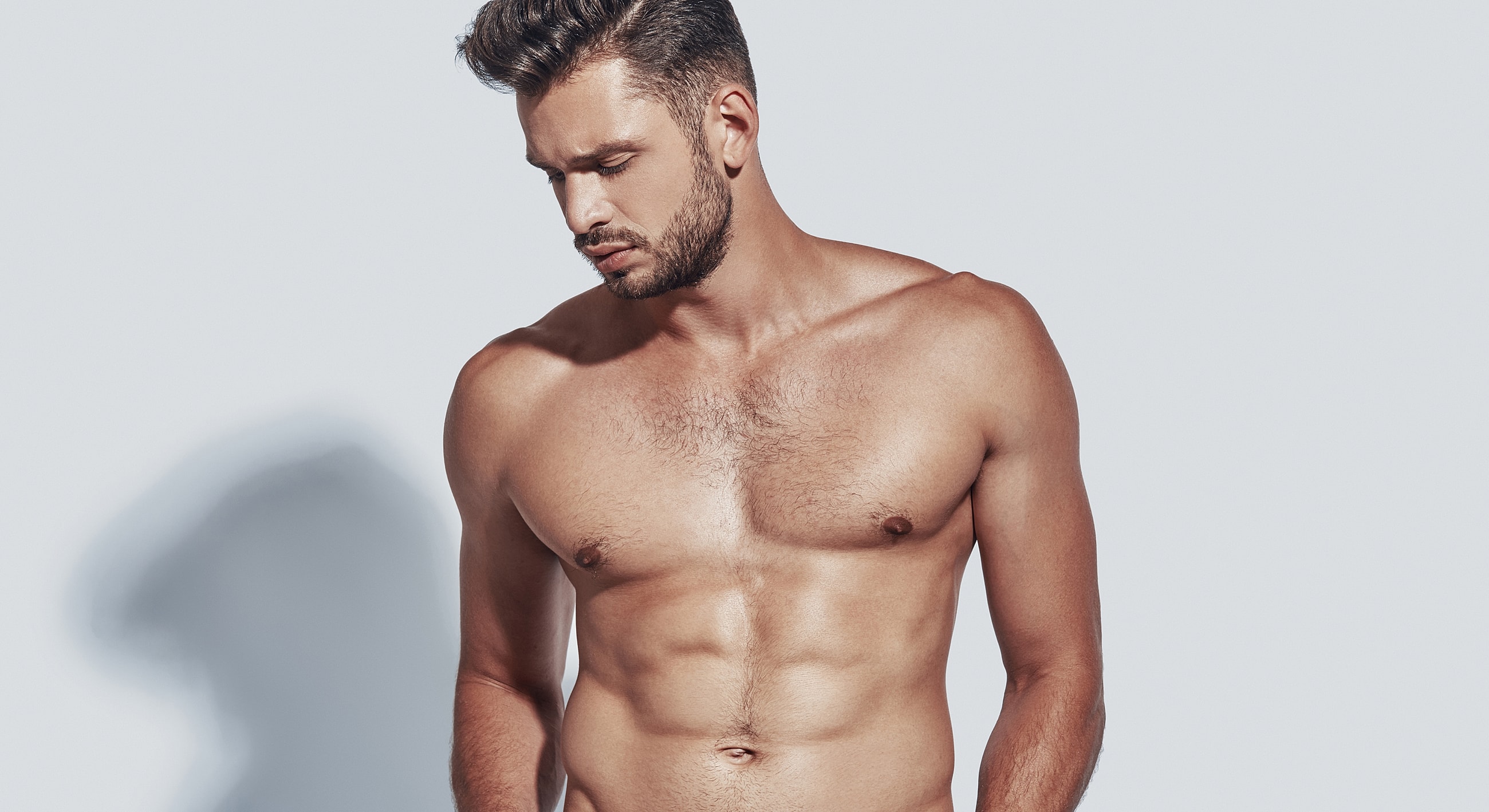 Male model posing against a light background