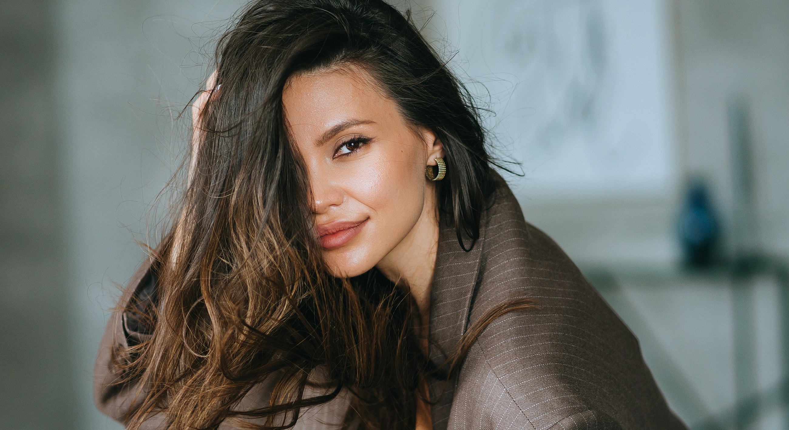 Woman with flowing hair and elegant attire.
